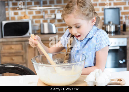 https://l450v.alamy.com/450v/hwnx5w/excited-little-girl-with-wooden-spoon-mixing-dough-in-glass-bowl-hwnx5w.jpg