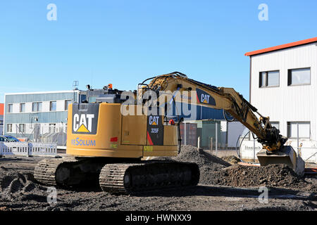 TURKU, FINLAND - MARCH 18, 2017: 325F L Medium Hydraulic Excavator om a construction site on a clear day with blue sky. Stock Photo