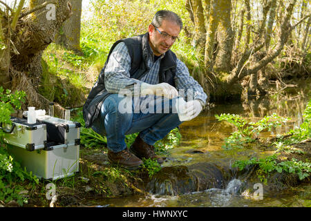 Scientist and biologist hydro-biologist takes water samples for analysis. Stock Photo