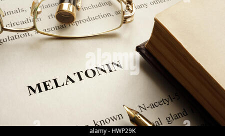 Paper with word Melatonin and book. Hormones concept. Stock Photo