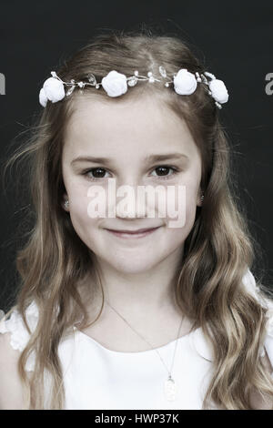 Portrait of a brown eyed girl on her first holy communion day Stock Photo