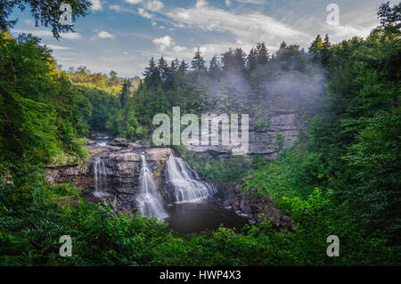 Small pockets of fog sweep in and out, hanging over the iconic Blackwater Falls of West Virginia on an early summer morning. Stock Photo