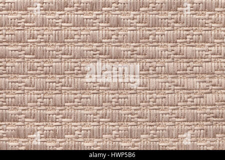 Light brown knitted woolen background with a pattern of soft, fleecy cloth. Texture of textile closeup. Stock Photo