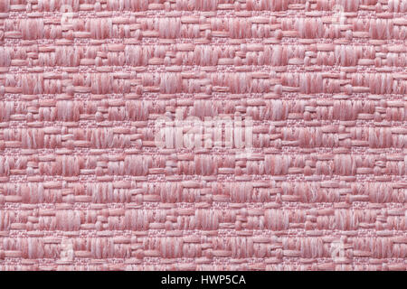 Light pink knitted woolen background with a pattern of soft, fleecy cloth. Texture of textile closeup. Stock Photo