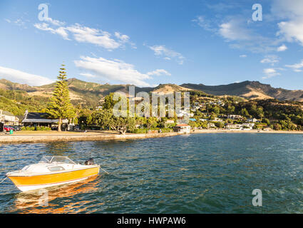 Summer afternoon over the idyllic Akaroa village in the Banks peninsula, close to the city of Christchurch, in New Zealand south island. Stock Photo