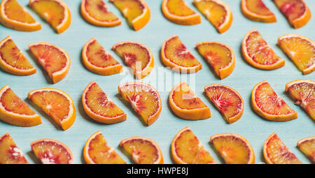 Fresh juicy blood orange slices placed in rows, selective focus Stock Photo