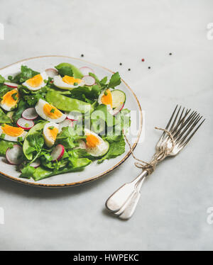 Healthy spring green salad with vegetables, pea and egg Stock Photo