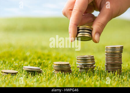 The columns of coins on grass Stock Photo