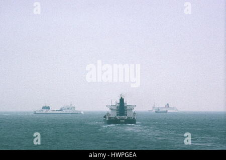 AJAXNETPHOTO. ENGLISH CHANNEL. - TRAFFIC SEPARATION - A TANKER HEADS EAST IN THE CHANNEL WITH TWO PASSENGER FERRIES CROSSING ITS PATH AHEAD TO PORT AND STARBOARD IN MISTY VISIBILITY. PHOTO:JONATHAN EASTLAND/AJAX REF:22506 1 75 Stock Photo