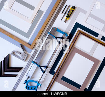 Overhead view of picture frames with work tools on table in workshop Stock Photo