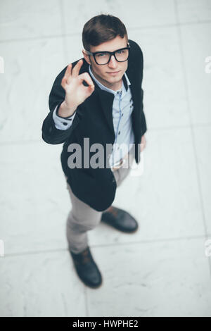 Young and beautiful businessman making ok sign . Top view. Stock Photo