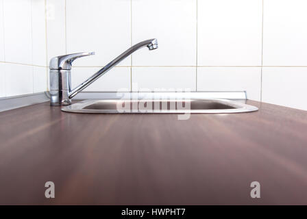 Close up view of stainless steel kitchen faucet and sink Stock Photo