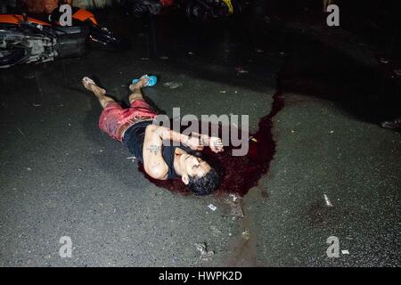 October 5, 2016 - Manila, National Capital Region, Philippines - The lifeless body of drug suspect Benjamin Visda lies in a pool of blood on a muddy unpaved road 100m from Tondo Police Station 1. Police at the scene claimed that Visda, who was handcuffed, had resisted arrest and was killed in a struggle after he had grabbed one of the officers' guns. Eyewitnesses at the scene who refused to be identified claimed that Visda was beaten by ununiformed police as he pleaded for his life before being shot in the back of the head. The claimed that the policemen then removed his handcuffs, which were  Stock Photo