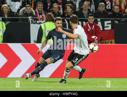 Dortmund, Germany. 22nd Mar, 2017. England's Kyle Walker (L) breaks through the defense from Germany's Jonas Hector during an international friendly match between Germany and England in Dortmund, Germany, on March 22, 2017. Germany won 1-0 and Germany's Lukas Podolski retired from German national team after this match. Credit: Shan Yuqi/Xinhua/Alamy Live News Stock Photo