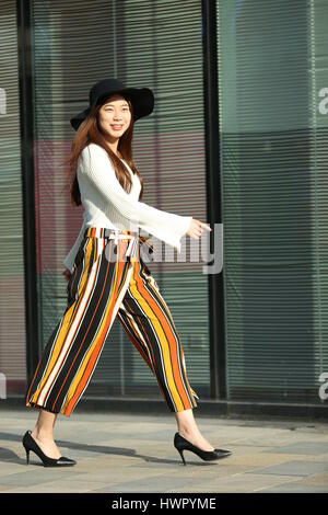 Beijin, Beijin, China. 23rd Mar, 2017. Beijing, CHINA-March 23 2017: (EDITORIAL USE ONLY. CHINA OUT) A chick girl walks along the street in Sanlitun, Beijing's fashion hub, March 23rd, 2017. Credit: SIPA Asia/ZUMA Wire/Alamy Live News Stock Photo