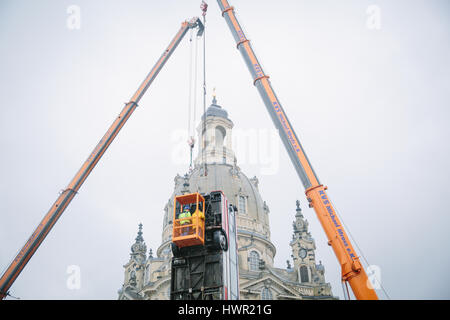 Dresden, Germany. 4th Apr, 2017. The bus installation 'Monument' is disassembled at the Neumarkt in Dresden, Germany, 4 April 2017. The three vertically placed busses of the artist Manaf Halbouni will be moved to the Gorki theatre in Berlin. Photo: Oliver Killig/dpa-Zentralbild/dpa/Alamy Live News