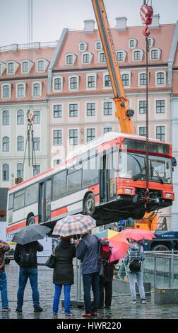Dresden, Germany. 4th Apr, 2017. The bus installation 'Monument' is disassembled at the Neumarkt in Dresden, Germany, 4 April 2017. The three vertically placed busses of the artist Manaf Halbouni will be moved to the Gorki theatre in Berlin. Photo: Oliver Killig/dpa-Zentralbild/dpa/Alamy Live News
