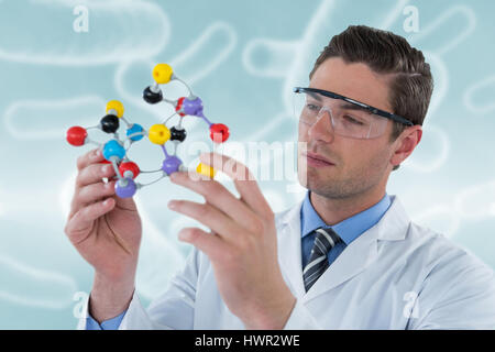 Scientist experimenting molecule structure against digital image of blue bacteria 3d Stock Photo