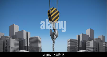 Studio Shoot of a crane lifting hook against blue sky background Stock Photo