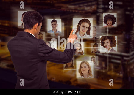Thoughtful asian businessman pointing against illuminated road in city at night Stock Photo