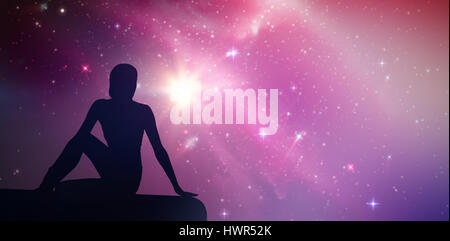 Fit woman doing the half spinal twist pose in fitness studio against aurora night sky in blue Stock Photo