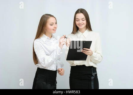 two business models standing with their backs together Stock Photo