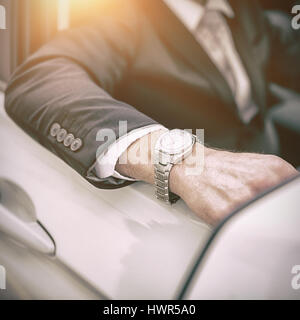 Arm of a man leaning on a car Stock Photo