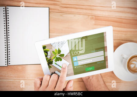 Close-up of login page against hands holding blank screen tablet Stock Photo