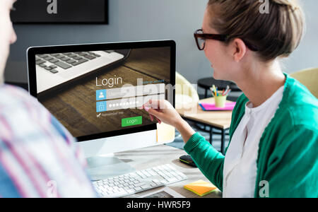Close-up of login page against business people discussing over computer monitor Stock Photo
