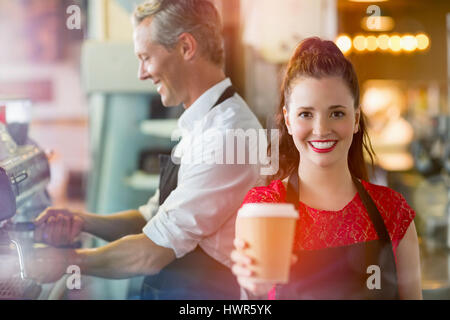 Graphic image of flare against barista offering coffee Stock Photo