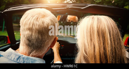 Rear view of mature couple going for ride together in classy convertible Stock Photo