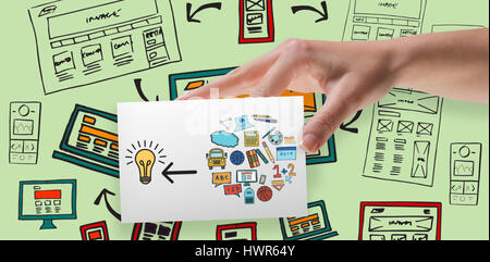 Female hand showing a card against green background Stock Photo