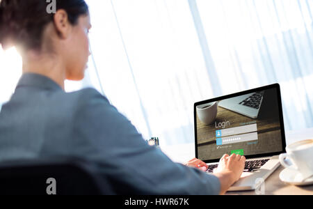 Close-up of login page against businesswoman typing on laptop Stock Photo
