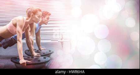 Side view of a muscular couple doing bosu ball exercises Stock Photo