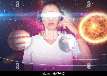 Beautiful woman with virtual video glasses against composite image of solar system against white background 3d Stock Photo
