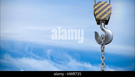 Studio Shoot of a crane lifting hook against view of blue sky and cloud Stock Photo