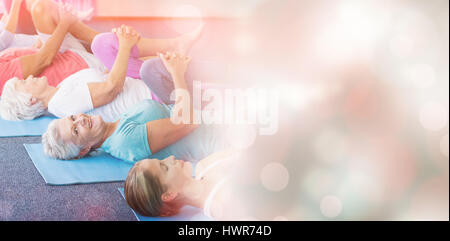 Instructor performing yoga with seniors during sports class Stock Photo