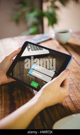 Close-up of login page against woman using her tablet pc Stock Photo