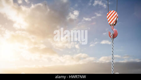 Studio Shoot of a crane lifting hook against cloudy sky landscape Stock Photo