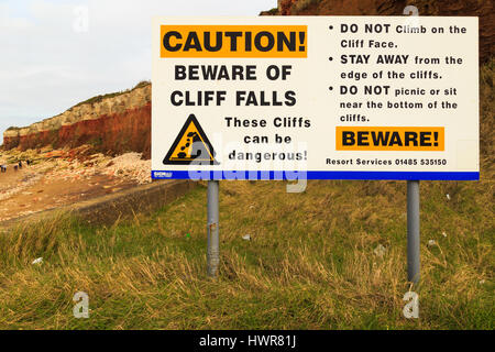 HUNSTANTON, ENGLAND - MARCH 10: Danger warning sign of cliff falls at Hunstanton beach, Norfolk. In Hunstanton, Norfolk, England. On 10th March 2017. Stock Photo