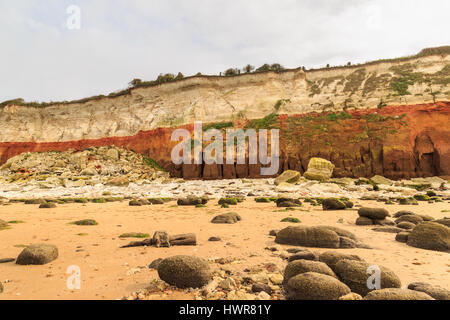 HUNSTANTON, ENGLAND - MARCH 10: White chalk and red sandstone cliffs, and beach at Hunstanton, Norfolk. HDR image. In Hunstanton, Norfolk, England. On Stock Photo