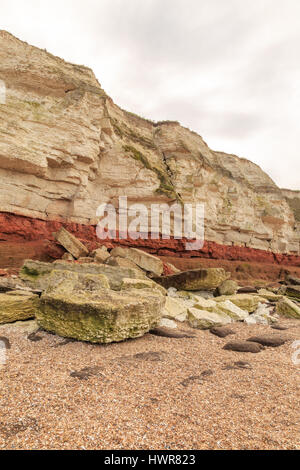 HUNSTANTON, ENGLAND - MARCH 10: Colourful white chalk and red sandstone geological cliff face formation at Hunstanton, Norfolk, England. HDR image. In Stock Photo
