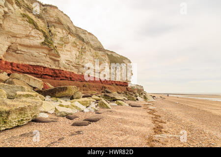HUNSTANTON, ENGLAND - MARCH 10: White chalk and red sandstone geological cliff face formation at Hunstanton, Norfolk, England. HDR image. In Hunstanto Stock Photo