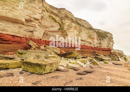 HUNSTANTON, ENGLAND - MARCH 10: Colour contrasting chalk and red sandstone geological cliff face formation at Hunstanton, Norfolk. HDR image. In Hunst Stock Photo