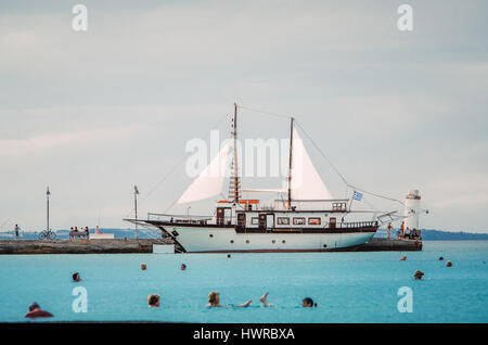 PEFKOHORI, GREECE - MAY 26, 2015: Sailing ship moored in marina of Pefkohori, Halkidiki, Greece, Aegean sea. After the sea trip to the Athos. People s Stock Photo