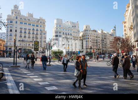 View over Plaza del Ayuntamiento (Modernisme Plaza of the City Hall of Valencia) with unidentified pedestrians crossing the street. Valencia, Spain. Stock Photo