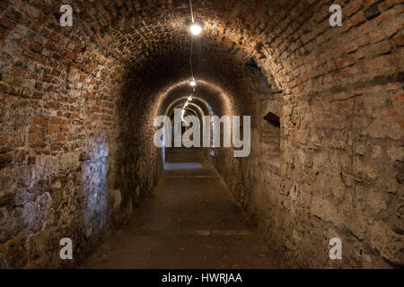 Long tunnel from stone and brick walls texture Stock Photo