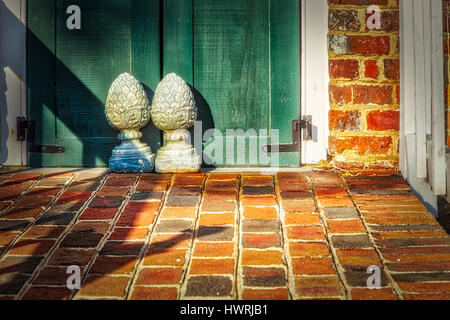 The sun rises on a pair of doors stops on the front patio of the Ferry Plantation House in Virginia Beach, VA.  https://en.wikipedia.org/wiki/Ferry Pl Stock Photo