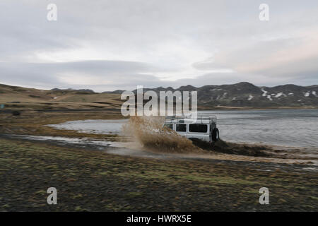 Land Rover driving off road through rugged Icelandic landscape. Stock Photo