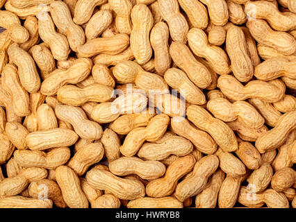 Peanuts in shell texture background. Raw peanuts on display at a farmer's market. Stock Photo